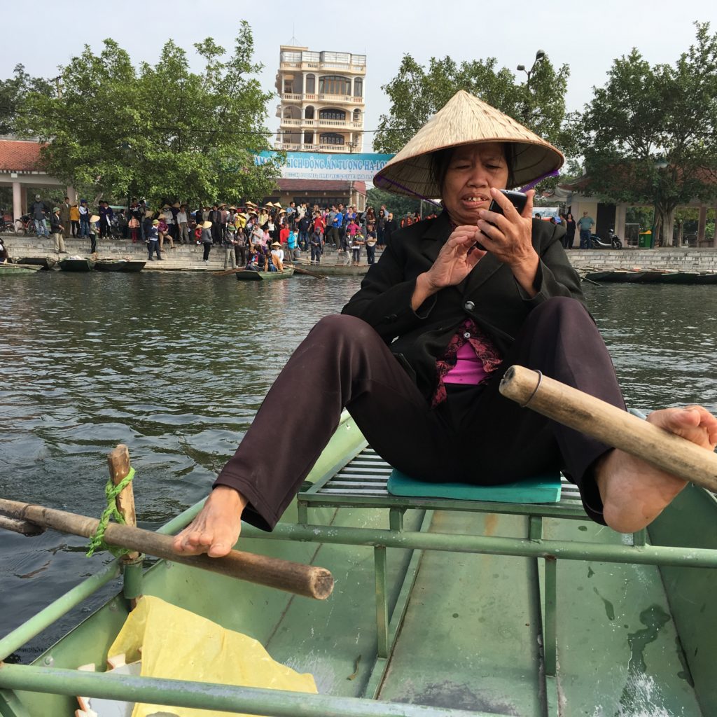 Rowing a boat in Tam Coc