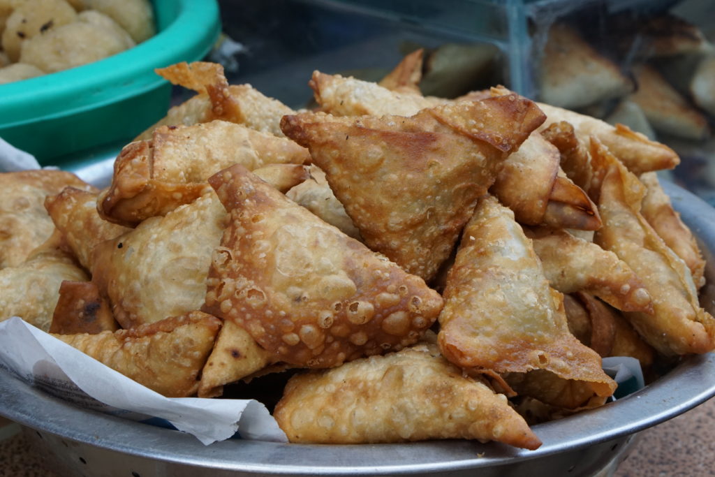Travel with your belly by cooking or trying food from different destination