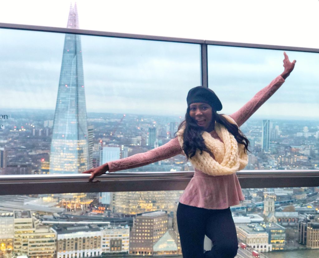 Woman at Sky Garden London. How to make a realistic travel budget
