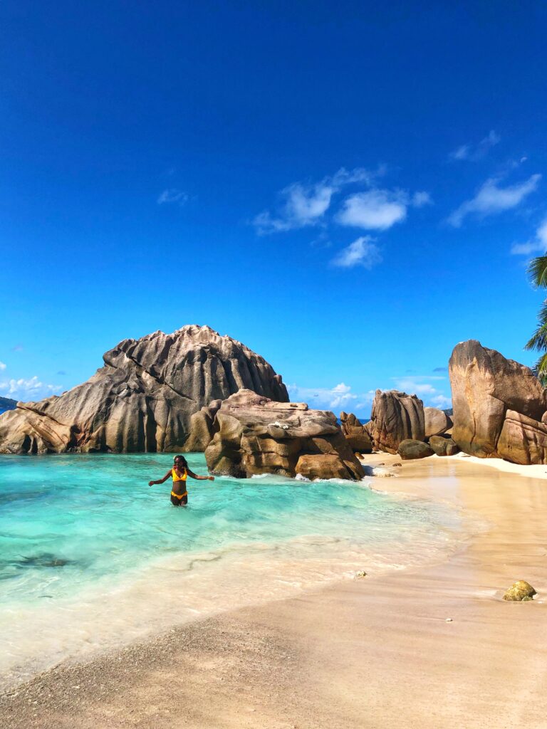 Woman on beach in la digue seychelles