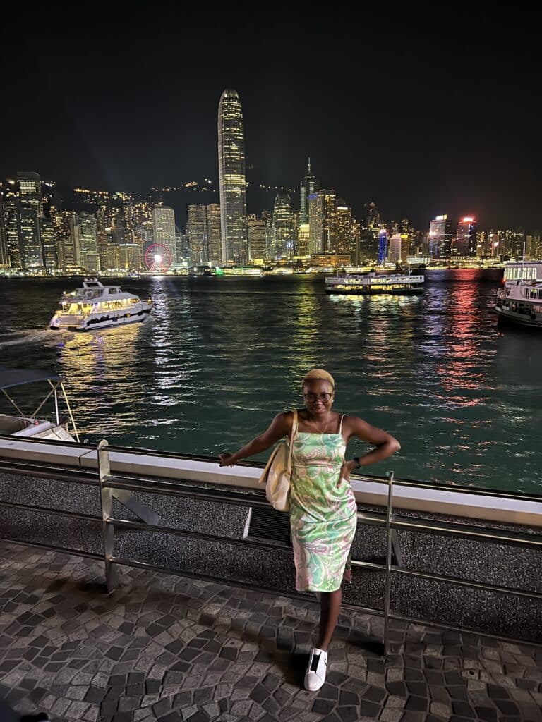 Black Woman at Star Ferry Pier Hong Kong at night