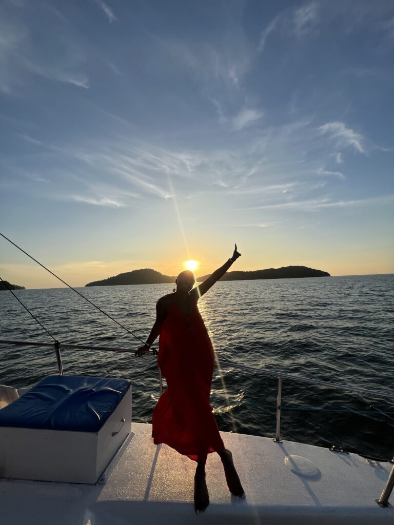 Black Woman in Red Dress on a boat in in Langkawi Malaysia