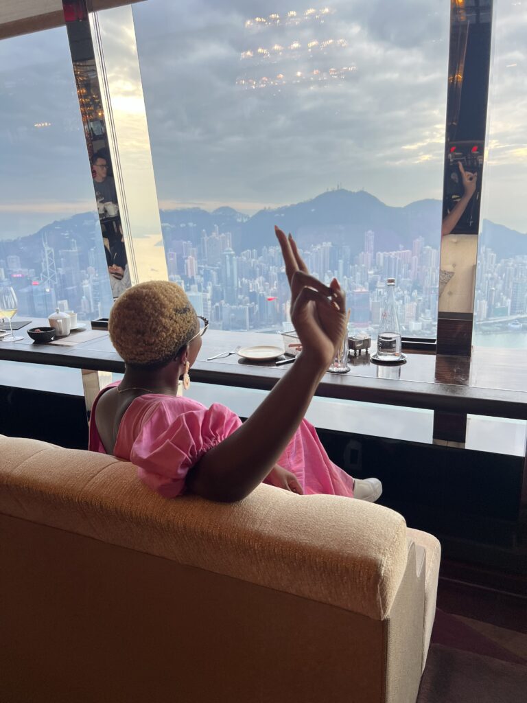 Black Woman traveling in Hong Kong taking in harbor views