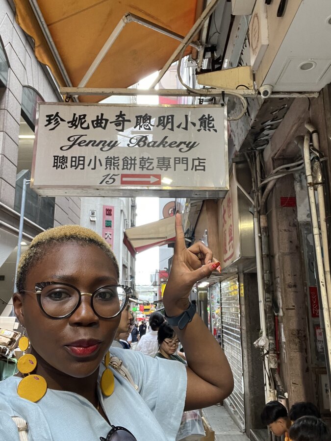 Woman outside Jenni's bakery in Hong Kong