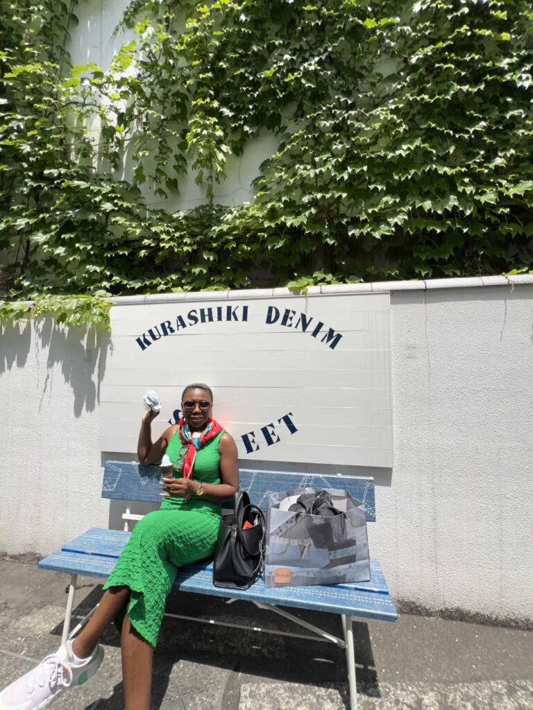 woman eating denim ice cream and denim portk bun on denim street in Kurashiki hiroshima