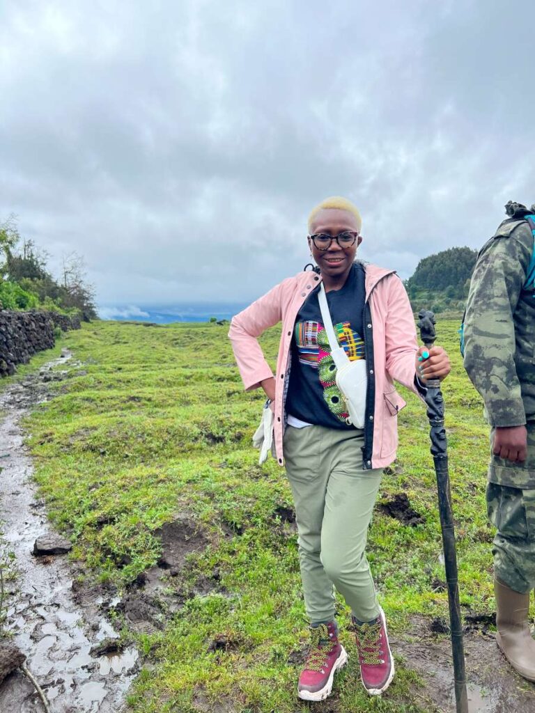 A woman with a trekking stick ready to trek to Volcanoes National Park, Rwanda