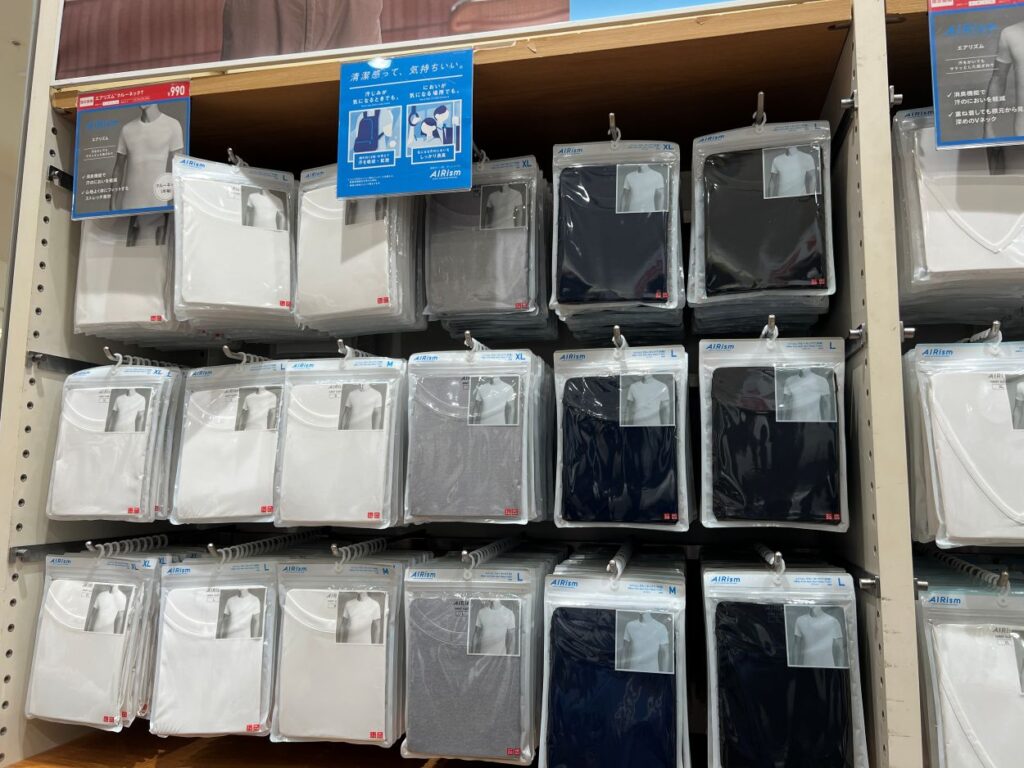 Stack of tank tops at Uniqlo Japan, a popular staples for travelers.