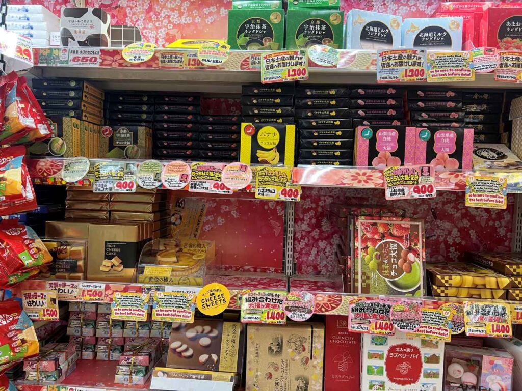 Boxes of Tokyo Milk Cheese Factory cookies in a store shelf, a popular omiyage from Japan.