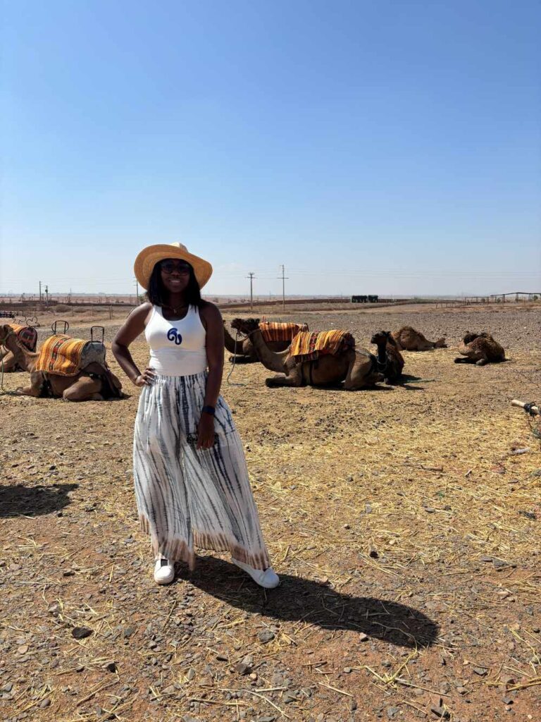 Dee with camels in the background at Marrakech Palmeraie.