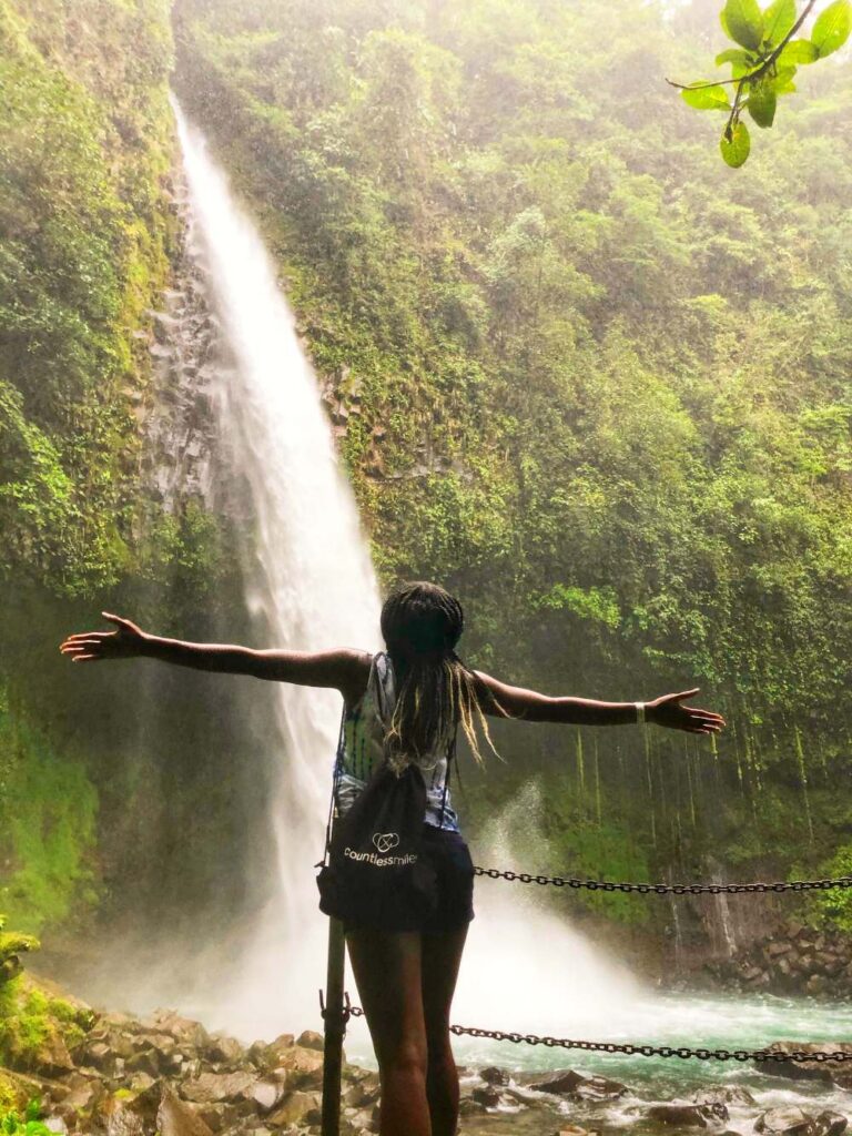 Hiking to a waterfall in Costa Rica’s rainforest, illustrating adventurous 40th birthday trip ideas