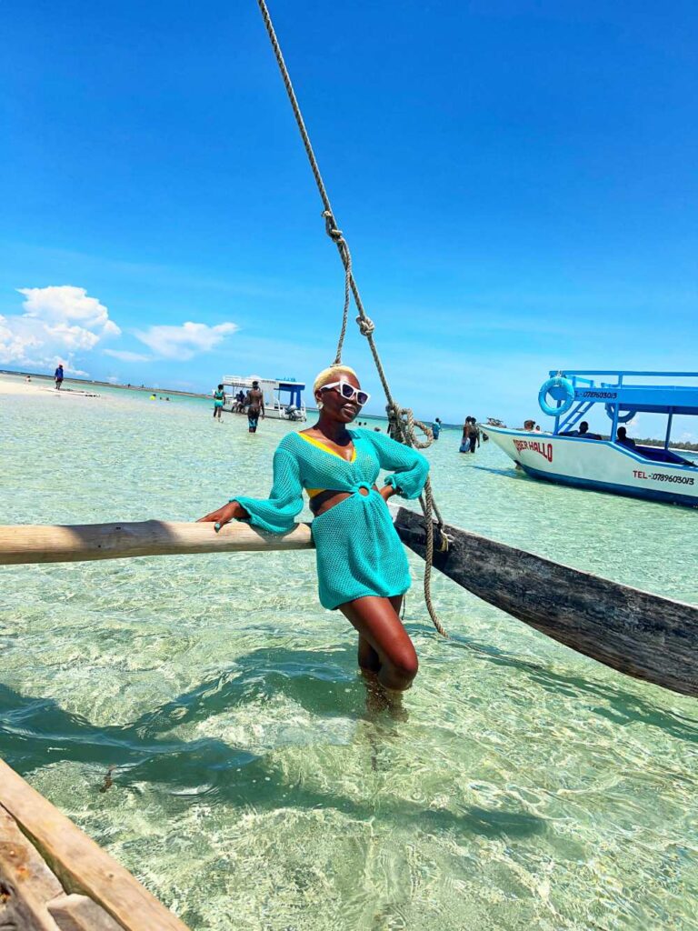 Woman enjoying Diani Beach in Kenya, showcasing beach-focused 40th birthday travel ideas
