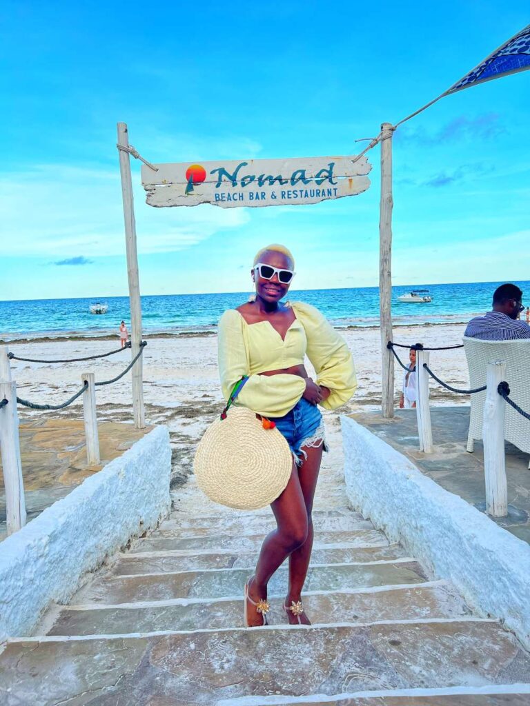 Woman soaking in the sun at Diani Beach, one of the most serene 40th birthday trip ideas