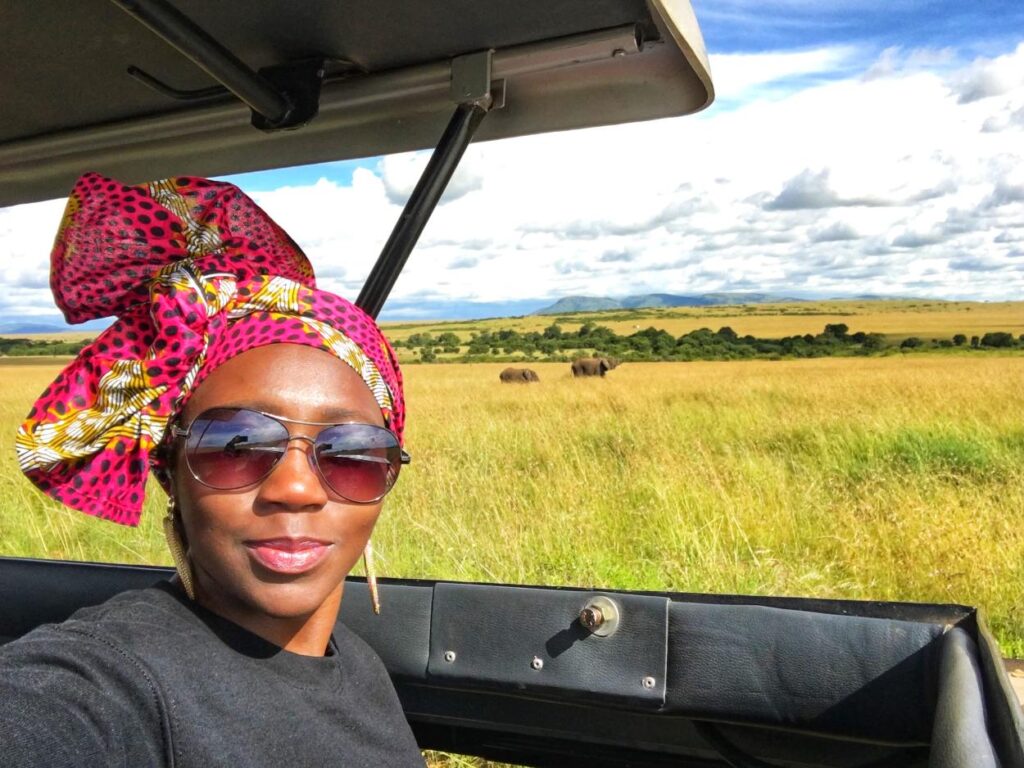 A woman on an African safari, capturing adventurous 40th birthday trip ideas for wildlife lovers