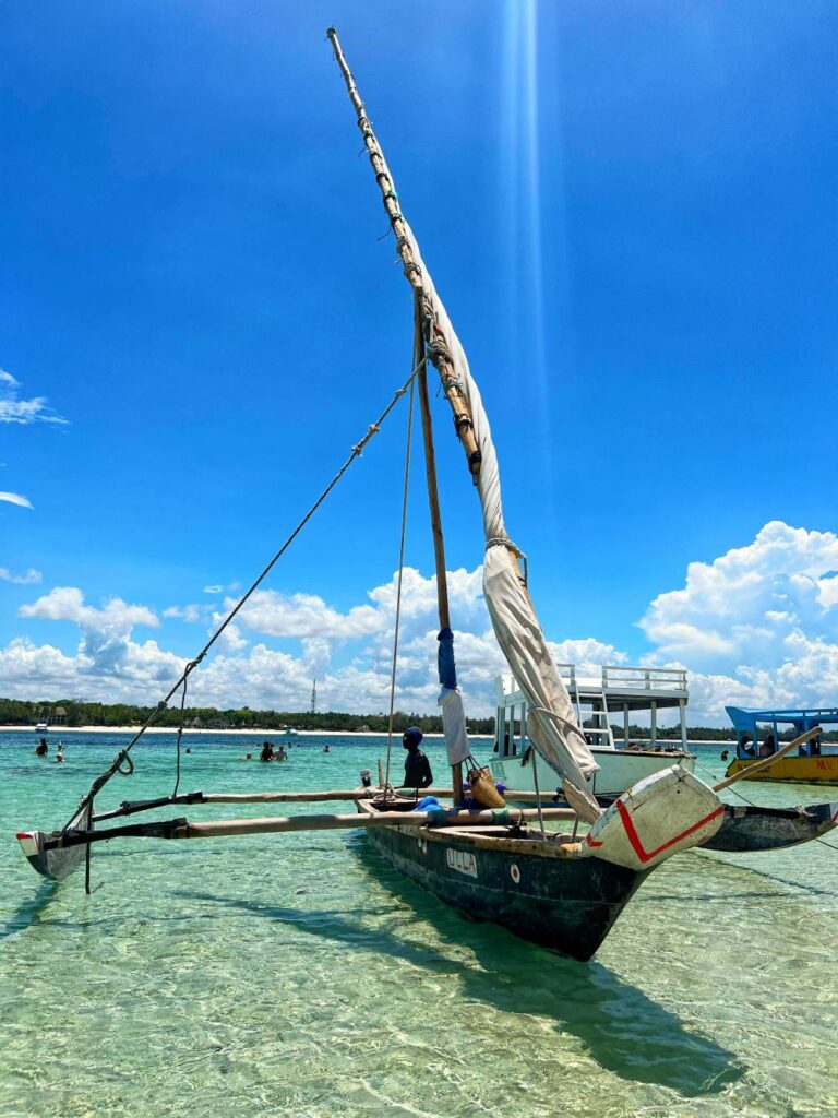 A woman by the turquoise waters of Zanzibar, representing relaxing 40th birthday getaway ideas