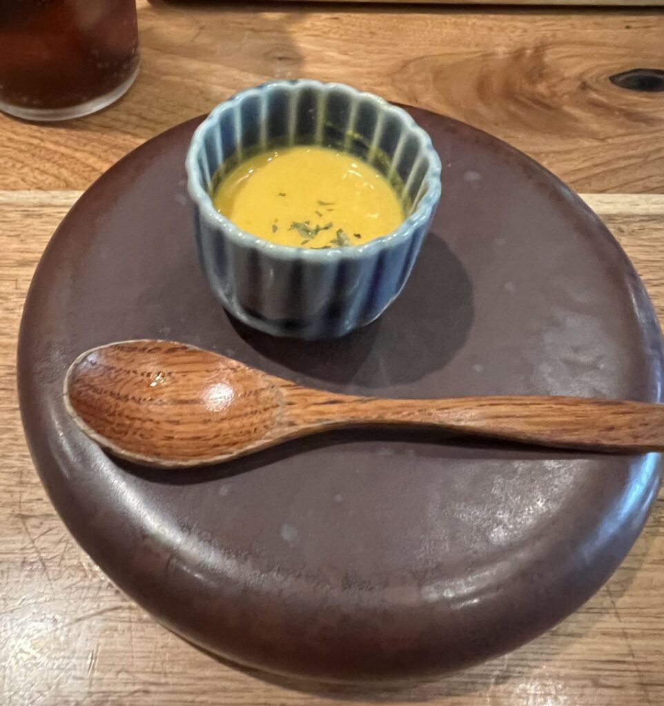 A bowl of pumpkin soup served to all diners at Ebimaru as a complimentary appetizer.