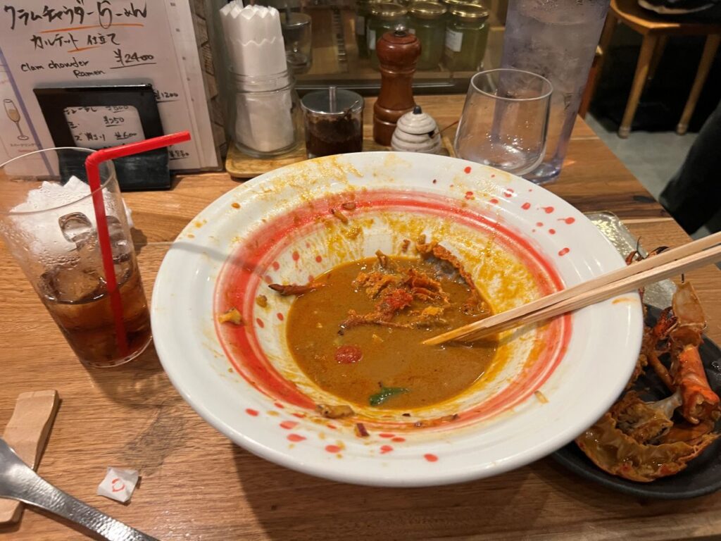 A happy diner shares a picture of her ramen bowl after relishing the lobster ramen at Ebimaru.