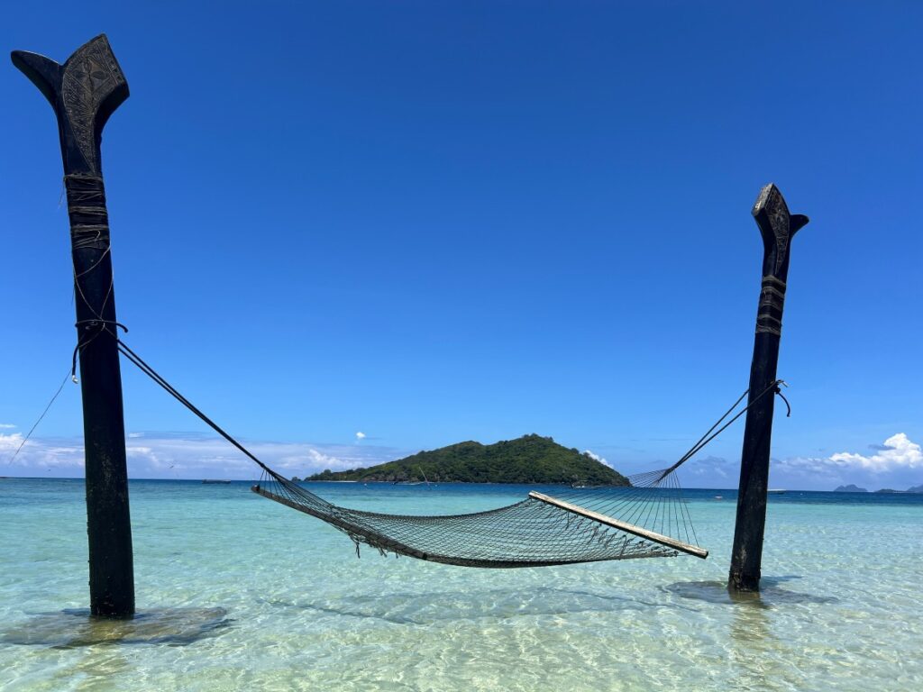 A hammock in the beach with panoramic views of the Yaro island, a unique experience for guests at Likuliku Lagoon Resort