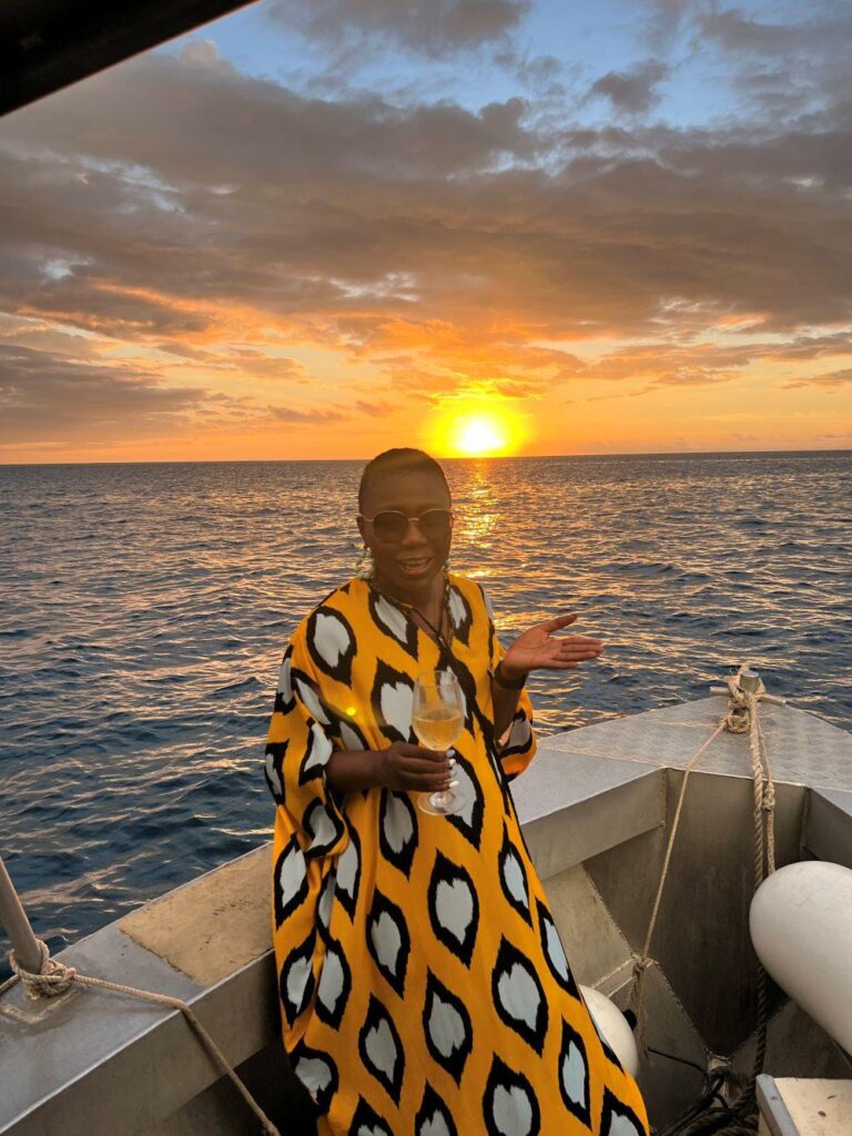 A guest at Likuliku Lagoon Resort on her way for snorkeling on a small fishing boat.