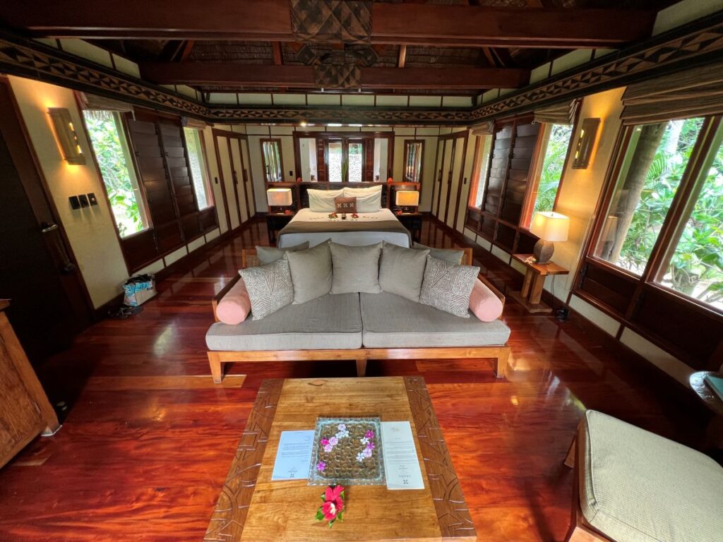 The interiors of the bure with wooden detailing and warm lighting at Likuliku Lagoon Resort