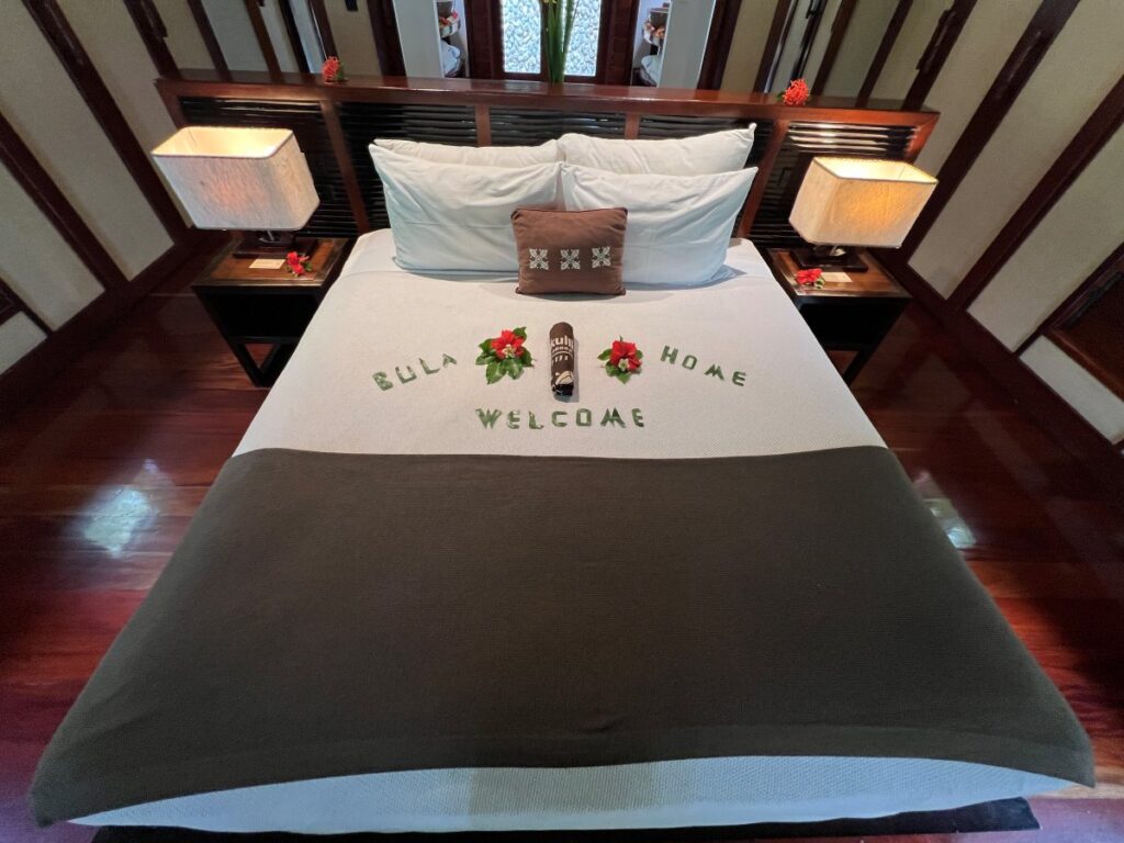The large double bed in a bure for a solo traveler at Likuliku Lagoon Resort, Fiji.