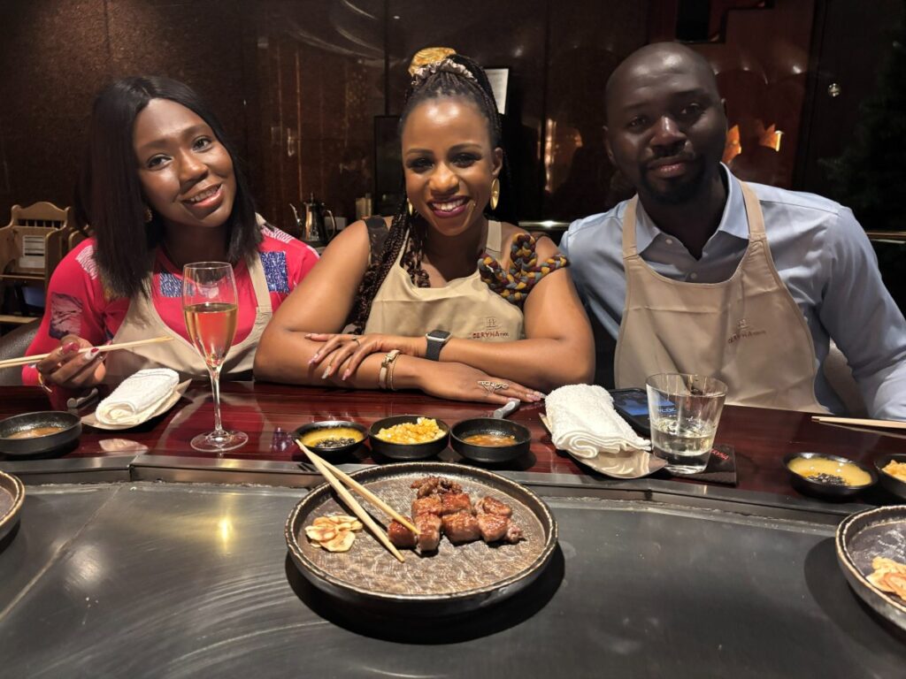 A Nigerian American global career woman enjoying a diner with friends in Japan while living there as an expat.