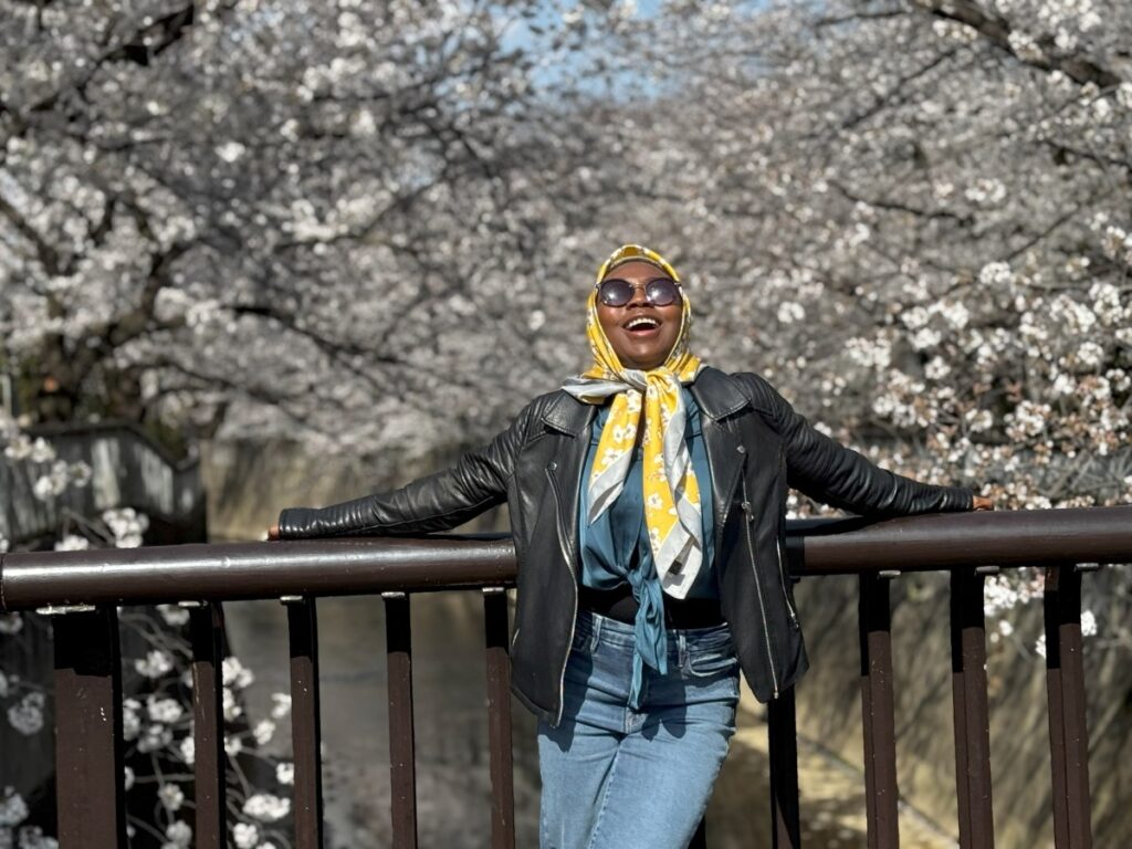 A global career woman exploring Tokyo during the cherry blossom season while living in Japan as an expat